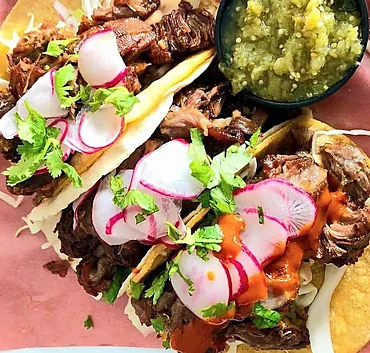 Carnitas tacos with radish and cilantro
