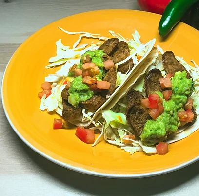 Chorizo tacos with guacamole and diced tomato