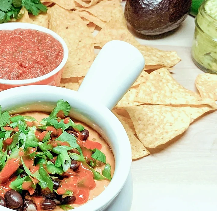 Queso fundido with black beans and a side of salsa