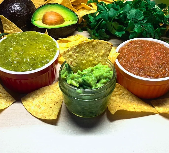 Salsa verde, guacamole and salsa rojas with tortilla chips