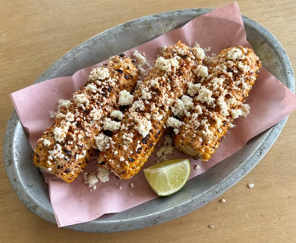 Three ears of street corn with creamy ancho spread and crumbled queso fresco